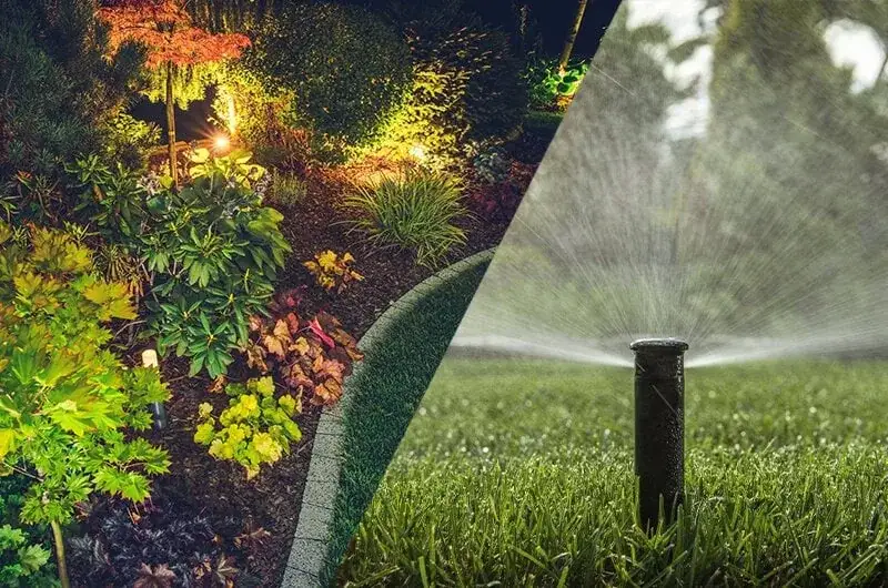 Pop-up sprinkler head watering a lawn beside a landscape bed lit at night in a Green Lake garden